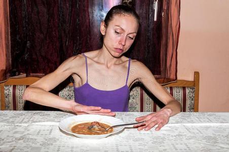 瘦骨嶙峋的厌食症女孩拒绝吃东西.照片